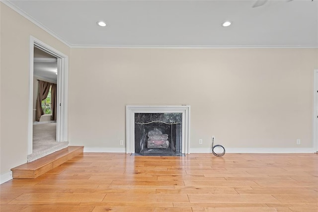 1616 SW 6th Ave, Ardmore, OK 73401 - unfurnished living room with crown molding, wood finished floors, a high end fireplace, recessed lighting, and baseboards