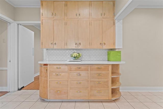 1616 SW 6th Ave, Ardmore, OK 73401 - kitchen featuring light countertops, decorative backsplash, light tile patterned floors, and baseboards