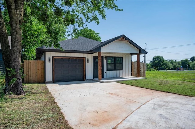 1435 NE 27th St, Oklahoma City, OK 73111 - view of front of property featuring an attached garage, board and batten siding, driveway, roof with shingles, and a porch