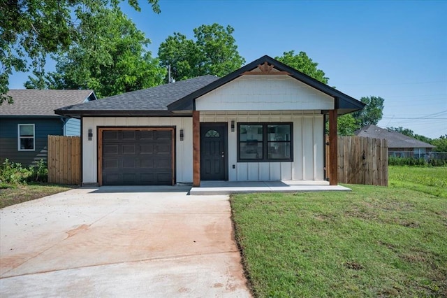 1435 NE 27th St, Oklahoma City, OK 73111 - ranch-style house featuring board and batten siding, an attached garage, driveway, roof with shingles, and covered porch