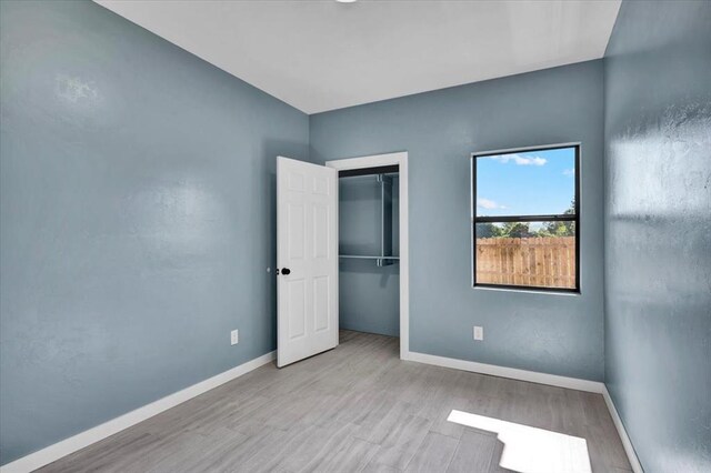 1435 NE 27th St, Oklahoma City, OK 73111 - unfurnished bedroom with wood finished floors, baseboards, and a closet
