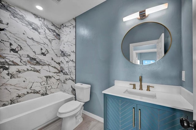 1435 NE 27th St, Oklahoma City, OK 73111 - bathroom with toilet, vanity, wood finished floors, and bathtub / shower combination