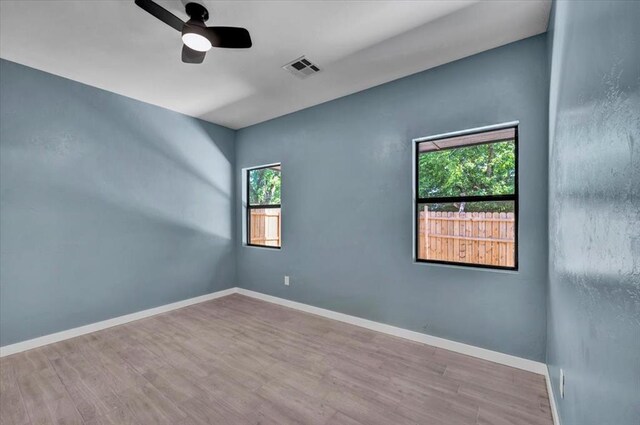 1435 NE 27th St, Oklahoma City, OK 73111 - unfurnished room with a ceiling fan, wood finished floors, and baseboards