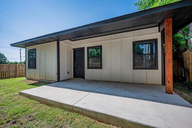 1435 NE 27th St, Oklahoma City, OK 73111 - rear view of property featuring board and batten siding and a patio area