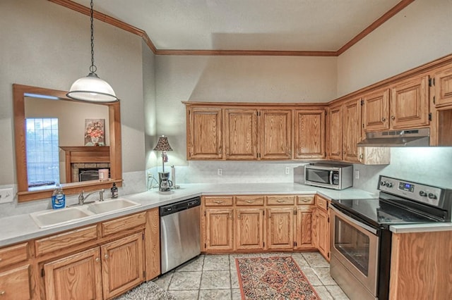 3100 Windward Ct, Norman, OK 73072 - kitchen with stainless steel appliances, under cabinet range hood, a sink, ornamental molding, and light countertops