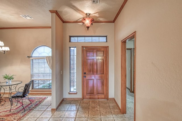 3100 Windward Ct, Norman, OK 73072 - entrance foyer with ornamental molding, a chandelier, baseboards, and a textured ceiling