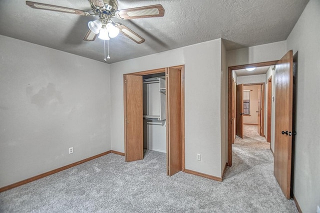 3100 Windward Ct, Norman, OK 73072 - unfurnished bedroom featuring light colored carpet, baseboards, a textured ceiling, a closet, and ceiling fan