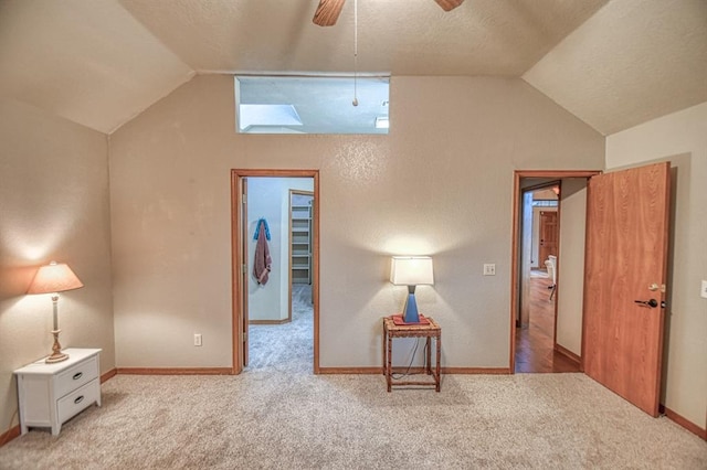 3100 Windward Ct, Norman, OK 73072 - carpeted bedroom featuring lofted ceiling, baseboards, a ceiling fan, and a skylight