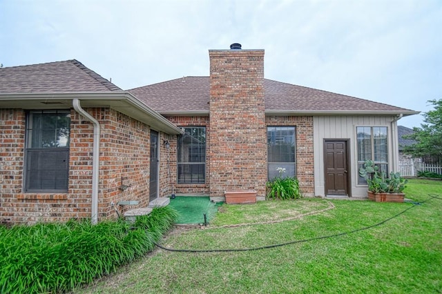 3100 Windward Ct, Norman, OK 73072 - rear view of property featuring roof with shingles, a yard, a chimney, and brick siding