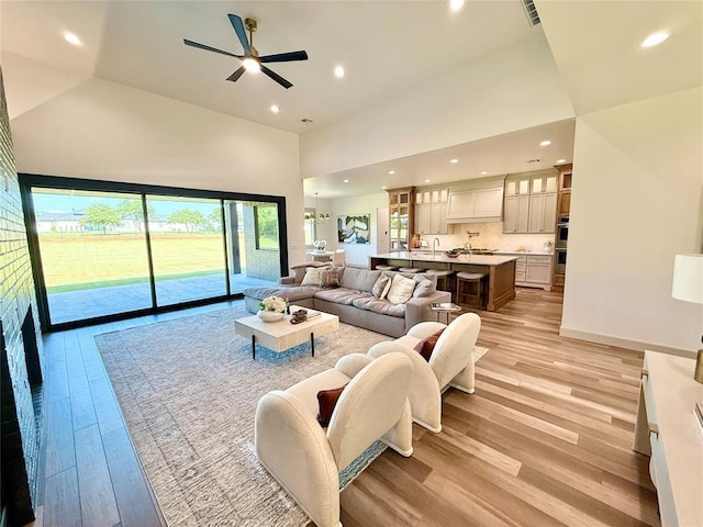 3320 Somerset Farms Rd, Newalla, OK 74857 - living room featuring high vaulted ceiling, light wood-type flooring, ceiling fan, and recessed lighting