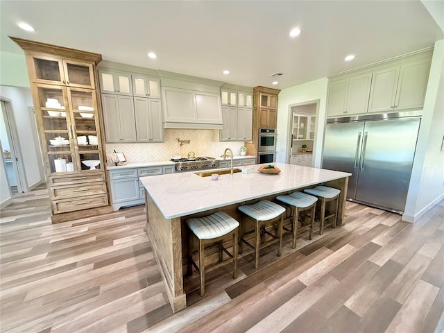 3320 Somerset Farms Rd, Newalla, OK 74857 - kitchen with appliances with stainless steel finishes, a sink, light wood-style flooring, backsplash, and recessed lighting