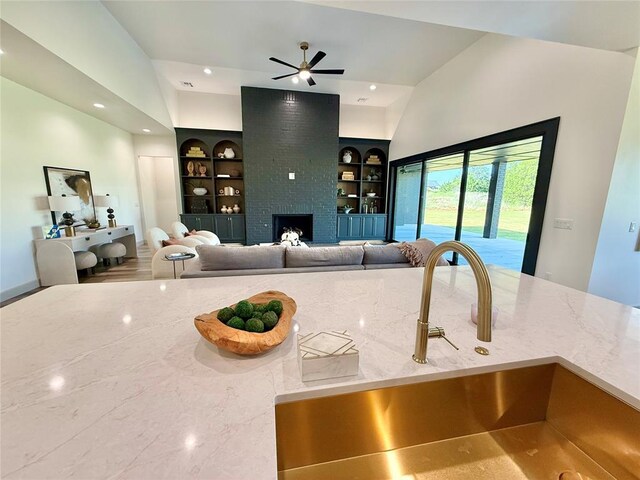 3320 Somerset Farms Rd, Newalla, OK 74857 - living area featuring built in shelves, recessed lighting, a brick fireplace, and a ceiling fan