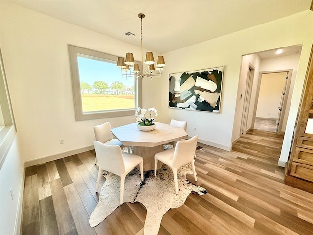 3320 Somerset Farms Rd, Newalla, OK 74857 - dining area with a chandelier, light wood-style flooring, and baseboards
