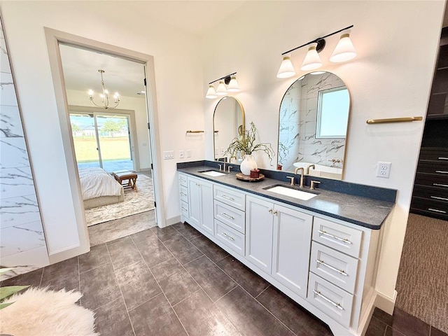 3320 Somerset Farms Rd, Newalla, OK 74857 - bathroom featuring double vanity, a chandelier, baseboards, and ensuite bath
