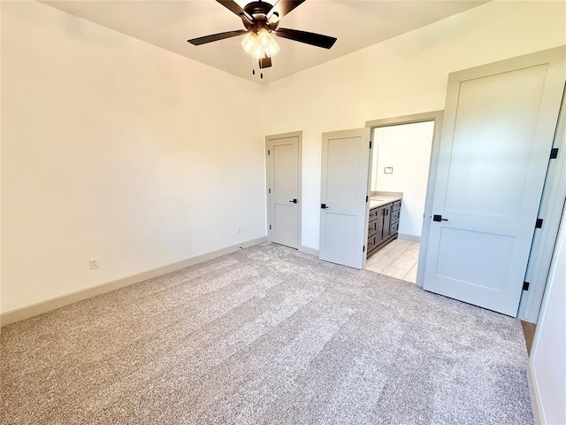 3320 Somerset Farms Rd, Newalla, OK 74857 - unfurnished bedroom with light colored carpet, baseboards, ensuite bathroom, and a ceiling fan