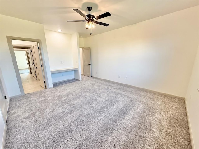 3320 Somerset Farms Rd, Newalla, OK 74857 - unfurnished bedroom with light colored carpet, baseboards, and a ceiling fan