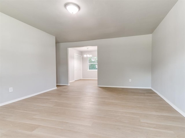 3522 SW 39th St, Oklahoma City, OK 73119 - empty room with a chandelier, baseboards, and light wood finished floors