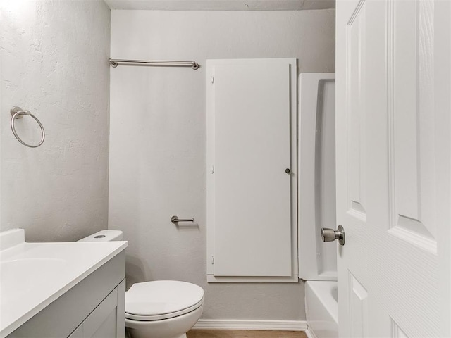 3522 SW 39th St, Oklahoma City, OK 73119 - full bathroom featuring vanity, toilet, a textured wall, baseboards, and shower / bath combination