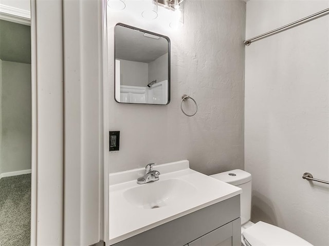 3522 SW 39th St, Oklahoma City, OK 73119 - bathroom featuring toilet, vanity, and a textured wall