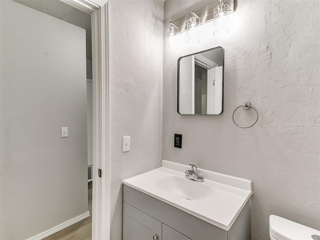 3522 SW 39th St, Oklahoma City, OK 73119 - half bathroom with vanity, toilet, and wood finished floors
