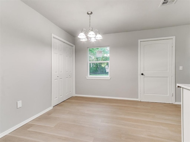 3522 SW 39th St, Oklahoma City, OK 73119 - empty room with light wood-style flooring, a chandelier, and baseboards