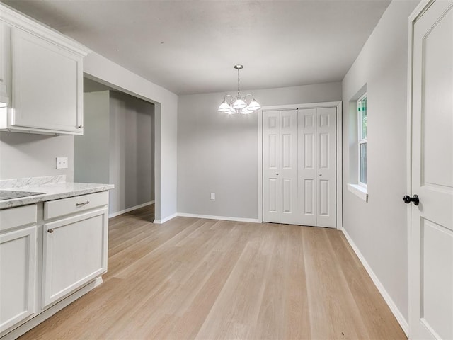 3522 SW 39th St, Oklahoma City, OK 73119 - unfurnished dining area featuring light wood-style floors, a chandelier, and baseboards