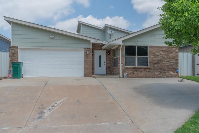 1217 SW 18th St, Oklahoma City, OK 73109 - view of front of property featuring concrete driveway, brick siding, and a garage