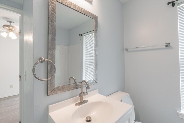 1217 SW 18th St, Oklahoma City, OK 73109 - bathroom with vanity, toilet, and wood finished floors