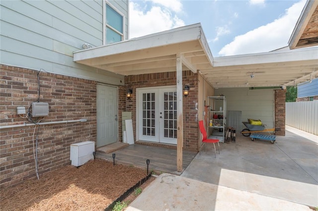 1217 SW 18th St, Oklahoma City, OK 73109 - property entrance with french doors, a patio area, brick siding, and a carport