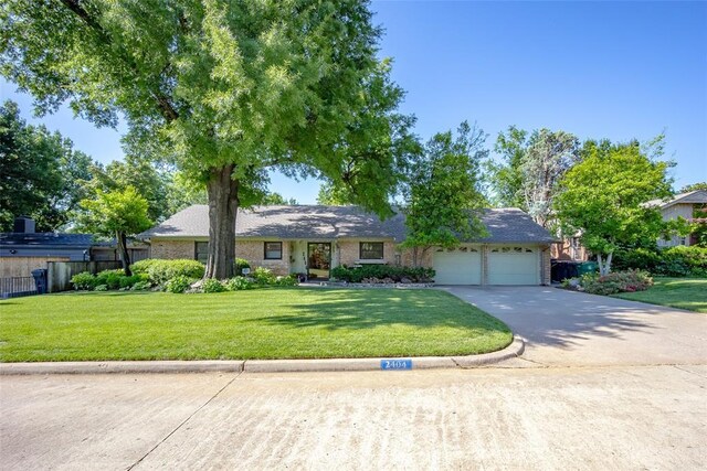 2404 NW 55th Ter, Oklahoma City, OK 73112 - ranch-style house featuring a garage and concrete driveway
