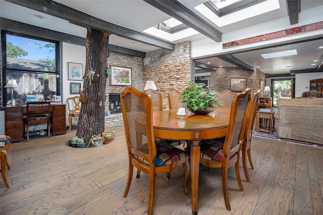 2404 NW 55th Ter, Oklahoma City, OK 73112 - dining room with beam ceiling, hardwood / wood-style floors, brick wall, and a skylight