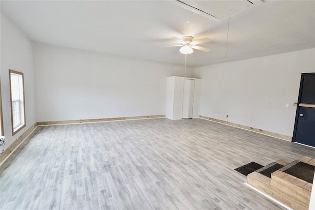 108174 N 3818th Rd, Okemah, OK 74859 - unfurnished living room featuring attic access, light wood-type flooring, baseboards, and ceiling fan