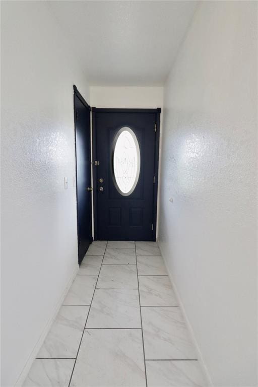108174 N 3818th Rd, Okemah, OK 74859 - doorway to outside featuring light marble finish flooring and baseboards