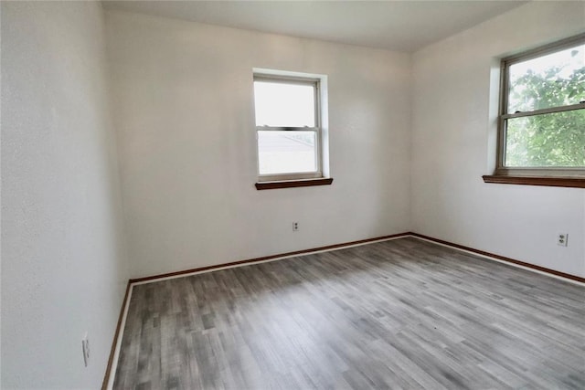 108174 N 3818th Rd, Okemah, OK 74859 - empty room featuring healthy amount of natural light, wood finished floors, and baseboards