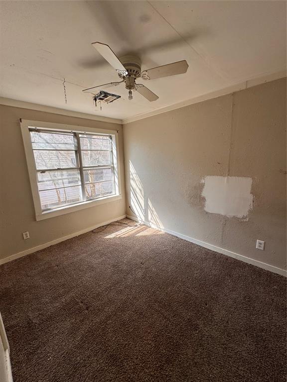 424 Jefferson St, Seminole, OK 74868 - empty room with baseboards, carpet, and ceiling fan