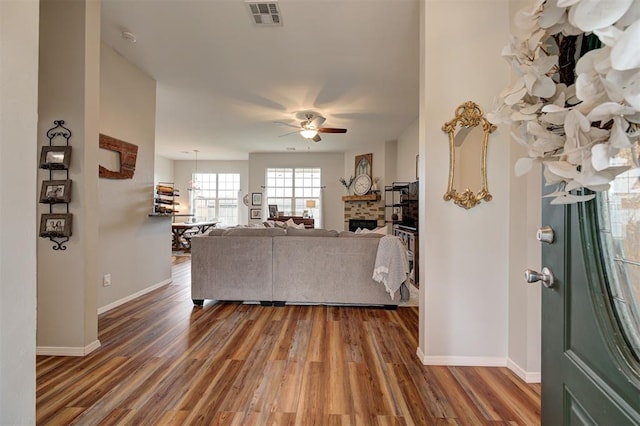 4236 Notting Hill Dr, Moore, OK 73160 - living room featuring a ceiling fan, wood finished floors, a fireplace, and baseboards