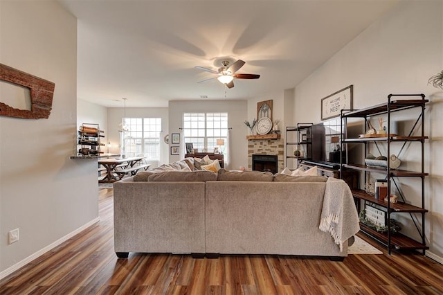 4236 Notting Hill Dr, Moore, OK 73160 - living room featuring ceiling fan, dark wood-style flooring, baseboards, and a fireplace