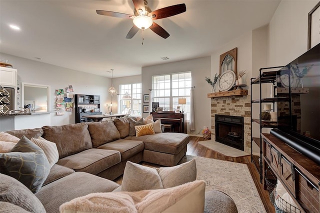 4236 Notting Hill Dr, Moore, OK 73160 - living area with wood finished floors, ceiling fan, and a fireplace