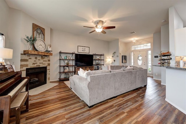 4236 Notting Hill Dr, Moore, OK 73160 - living room featuring a ceiling fan, wood finished floors, a fireplace, and baseboards
