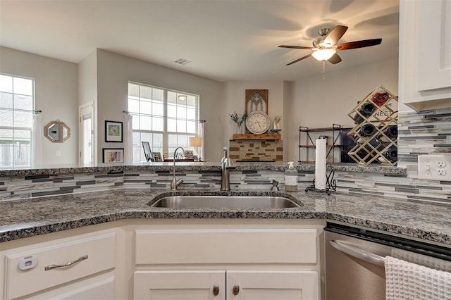 4236 Notting Hill Dr, Moore, OK 73160 - kitchen with a sink, dishwasher, ceiling fan, white cabinets, and dark stone counters