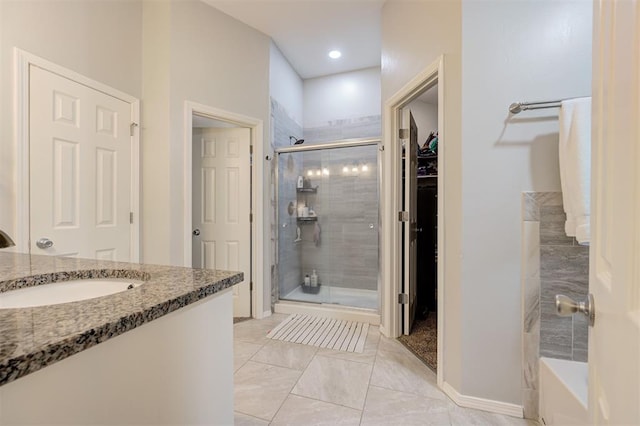 4236 Notting Hill Dr, Moore, OK 73160 - full bathroom with a stall shower, a walk in closet, vanity, and baseboards