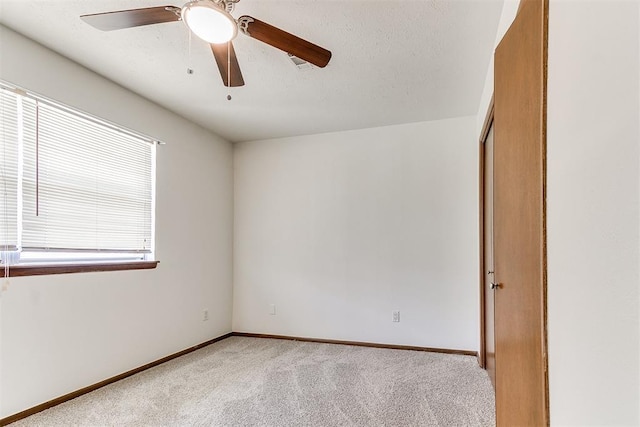 7620 NW 28th Ter, Bethany, OK 73008 - spare room featuring light carpet, a ceiling fan, and baseboards