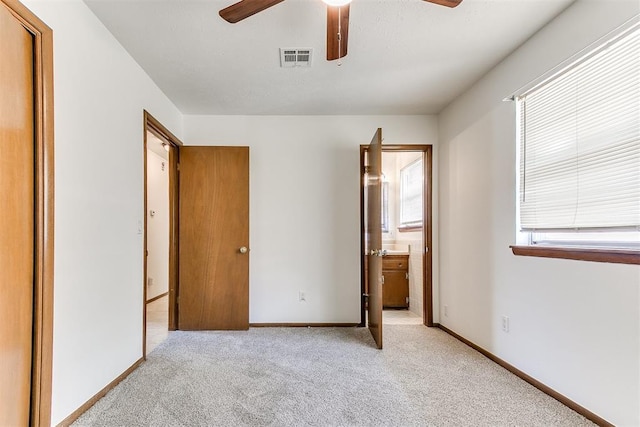 7620 NW 28th Ter, Bethany, OK 73008 - unfurnished bedroom featuring light carpet, baseboards, ensuite bath, and ceiling fan