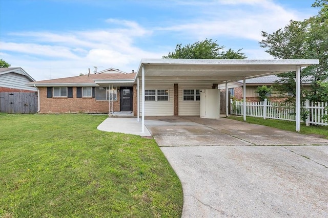 912 SW 4th Pl, Moore, OK 73160 - ranch-style house with driveway, brick siding, and a carport