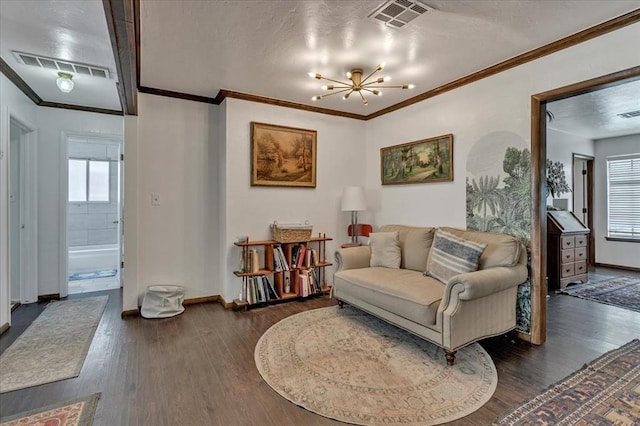 912 SW 4th Pl, Moore, OK 73160 - living area featuring a chandelier, dark wood-type flooring, baseboards, and crown molding
