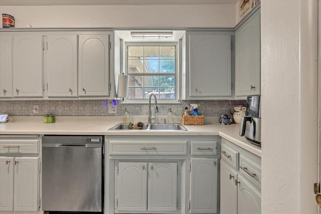 912 SW 4th Pl, Moore, OK 73160 - kitchen with stainless steel dishwasher, a sink, and light countertops