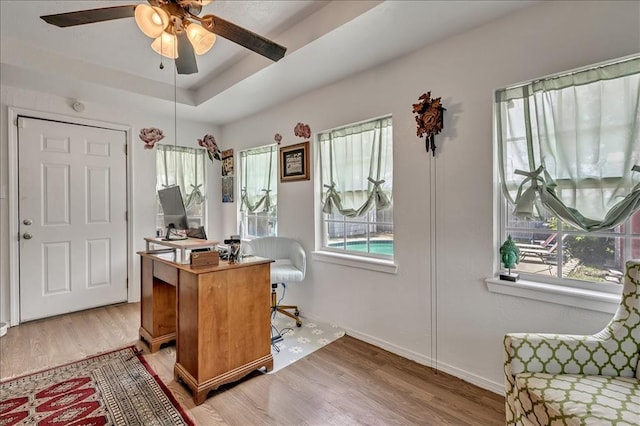 912 SW 4th Pl, Moore, OK 73160 - home office with light wood finished floors, a ceiling fan, baseboards, and a raised ceiling