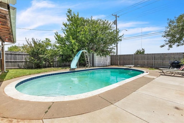 912 SW 4th Pl, Moore, OK 73160 - view of swimming pool featuring a water slide, a patio, a fenced backyard, and a diving board