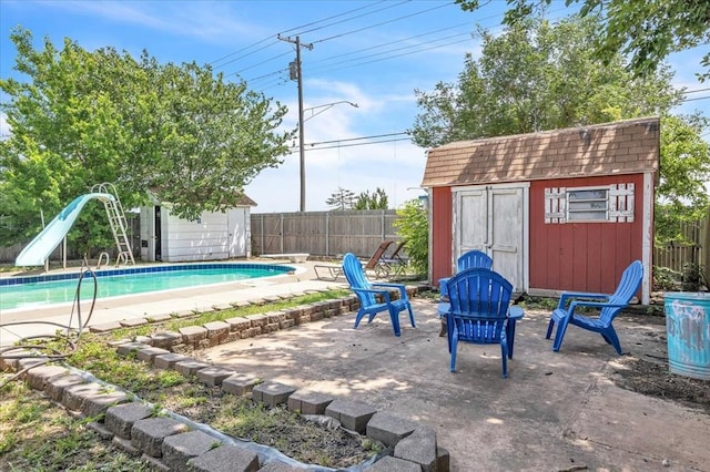 912 SW 4th Pl, Moore, OK 73160 - view of swimming pool with a water slide, a fenced backyard, a patio, and a diving board