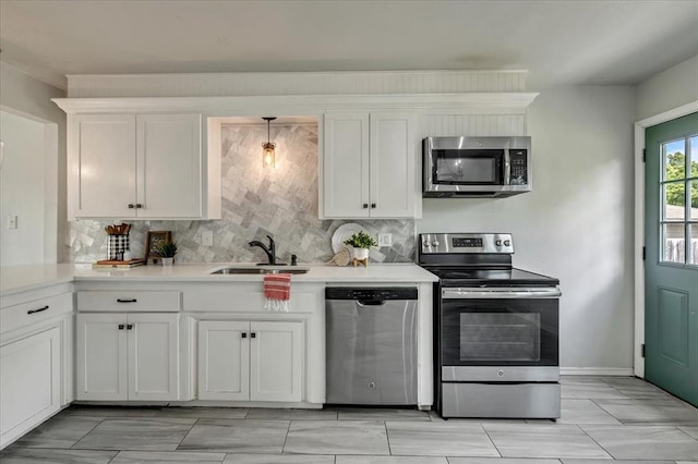 615 Ridgecrest Rd, Edmond, OK 73013 - kitchen featuring appliances with stainless steel finishes, a sink, decorative backsplash, white cabinetry, and light countertops